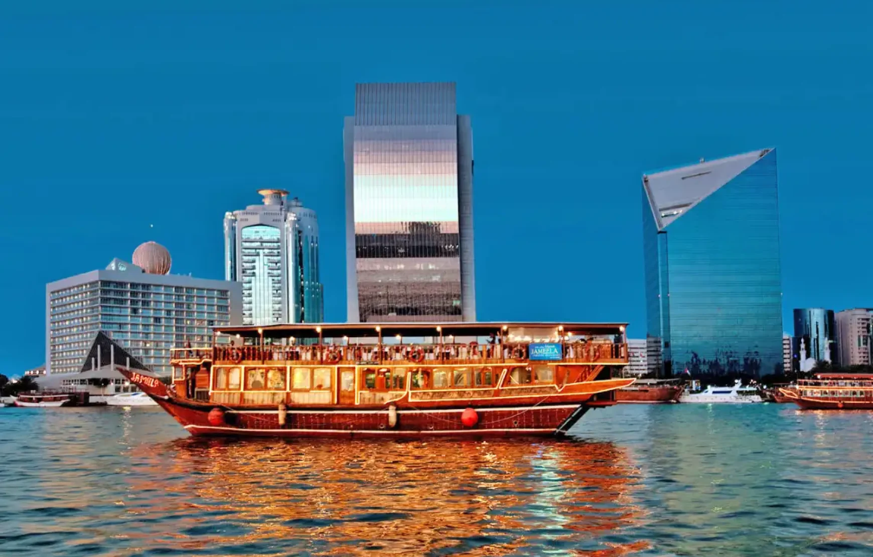 Dinner-on-Traditional-Wooden-Boat-Cruise-in-Dubai-Creek Dinner-on-Traditional-Wooden-Boat-Cruise-in-Dubai-Creek